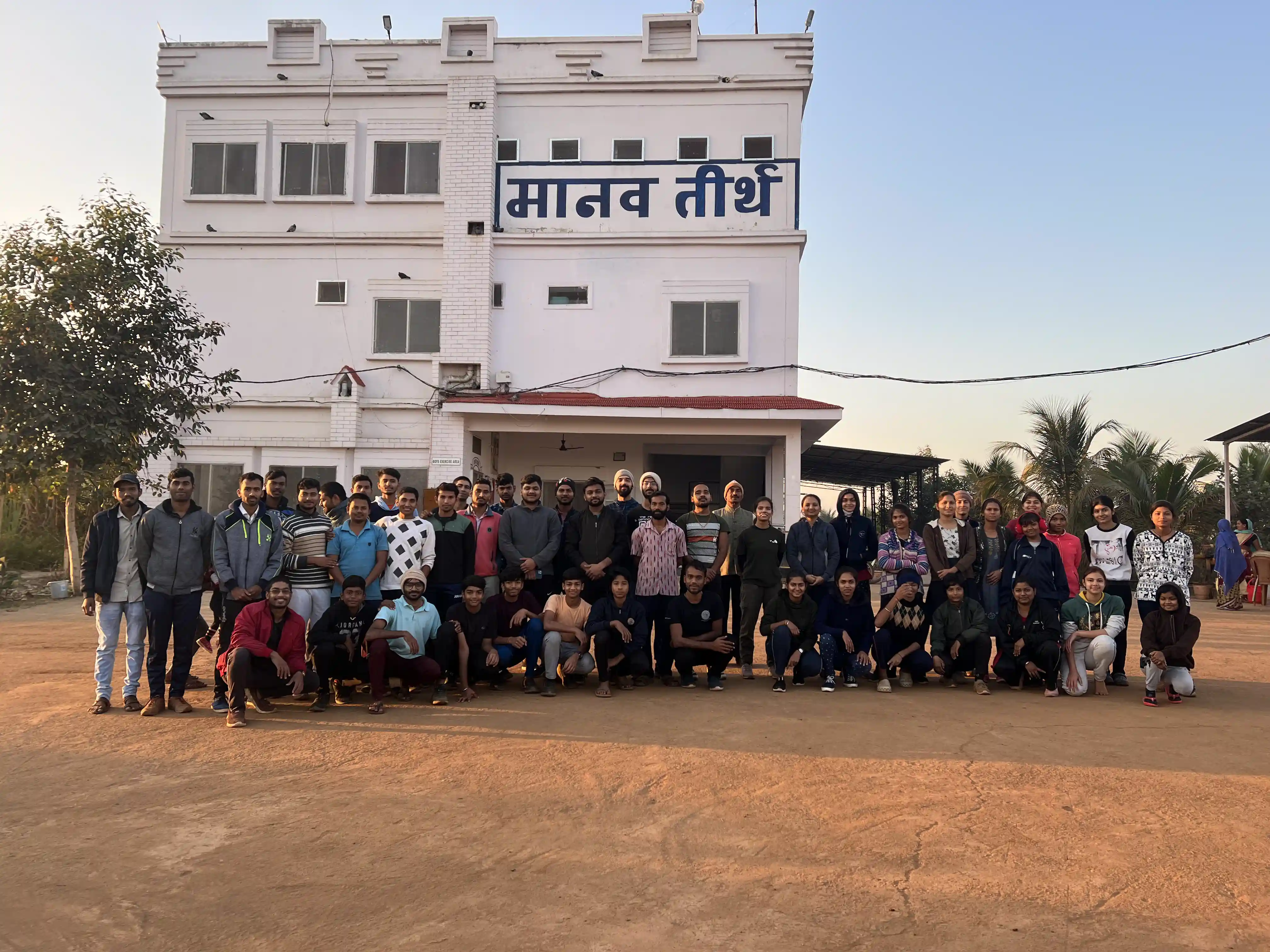Students and staff of Manav Teerth gathered in front of the campus building in Bemetara, Chhattisgarh